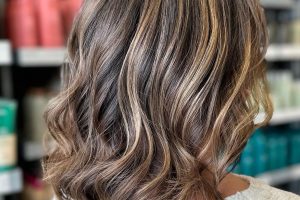 golden dimensional highlight on shoulder length wavy bobbed brunette