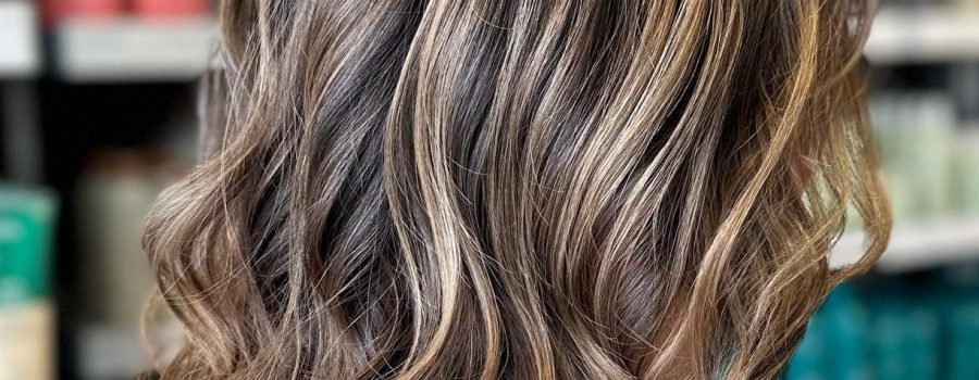 golden dimensional highlight on shoulder length wavy bobbed brunette