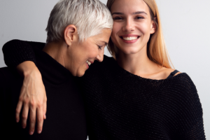 Mother and daughter smiling and hugging