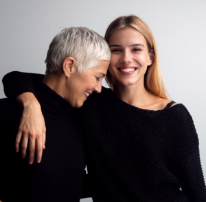 Mother and daughter smiling and hugging