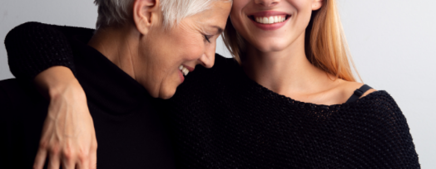 Mother and daughter smiling and hugging