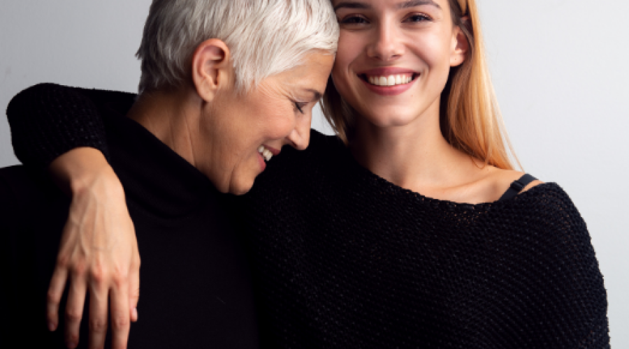 Mother and daughter smiling and hugging