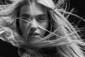 bw image of girl with long straight hair blowing up around her face