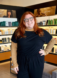 CND Shellac certified nail technician standing in the retail area of a Woodhaven mi spa