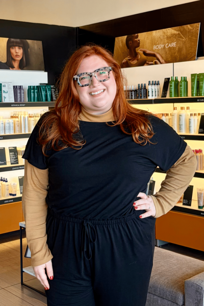 CND Shellac certified nail technician standing in the retail area of a Woodhaven mi spa