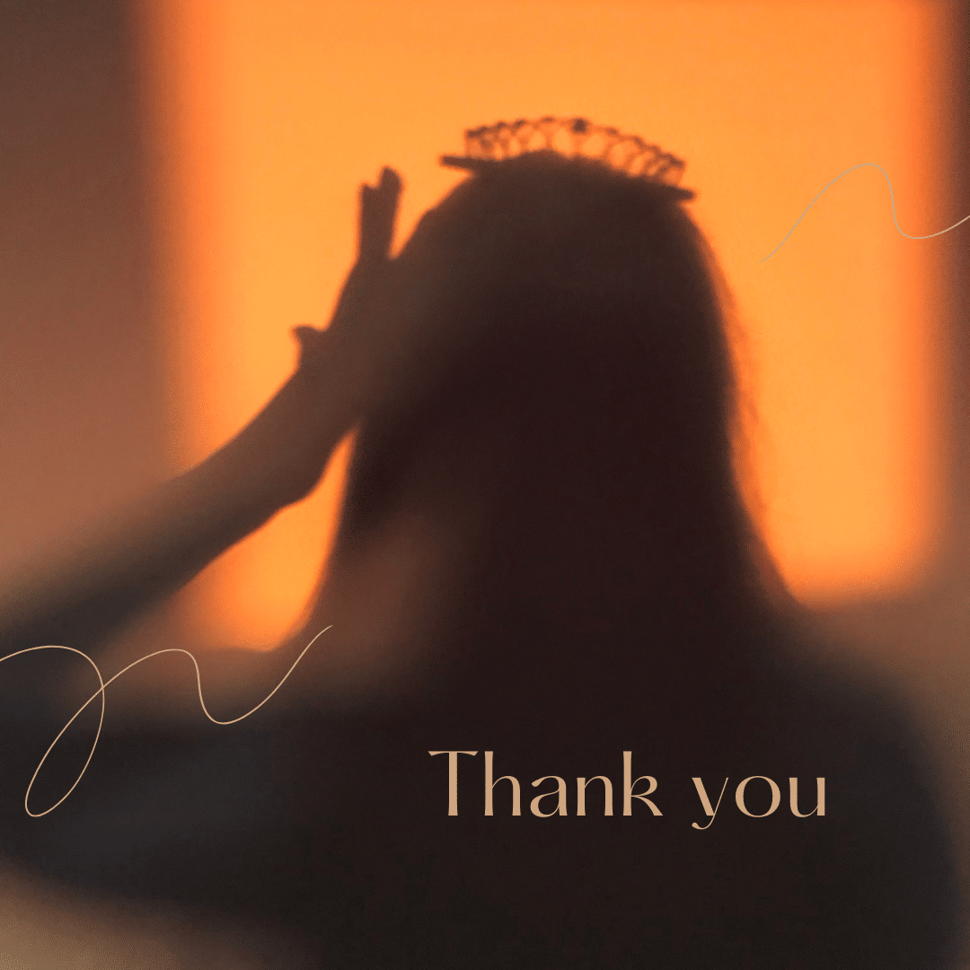 woman adjusting crown on her head, in front of daybreak lighting